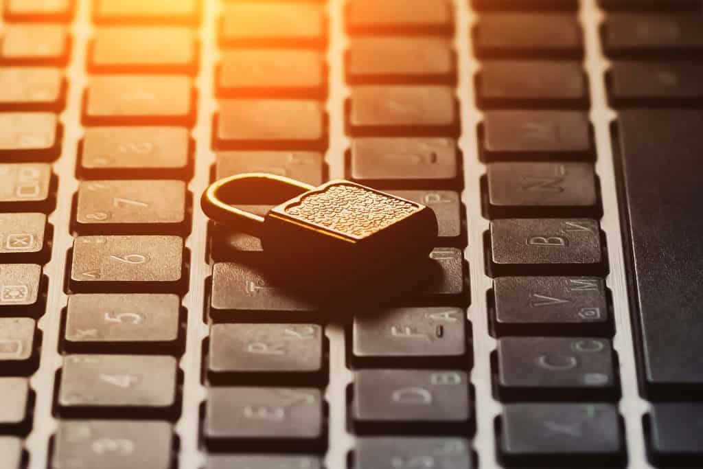 Compromised laptop keyboard with a padlock symbolising cybersecurity and data protection.