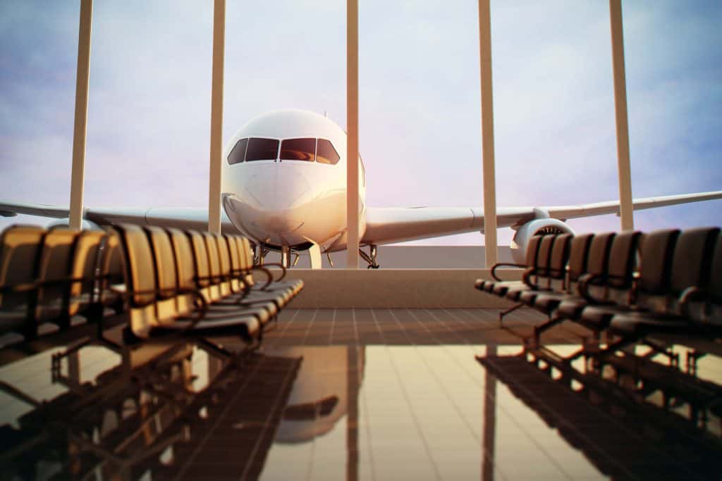 Aircraft at airport terminal with seating area in foreground, focusing on social media on holiday insurance services.