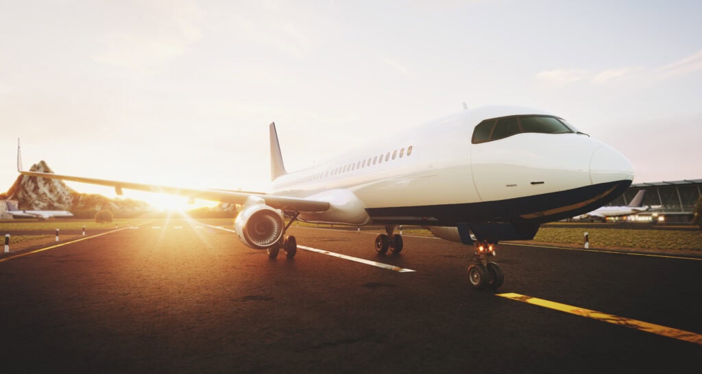 Private jet on runway during sunset, luxury aircraft, air travel insurance, aviation insurance services UK.