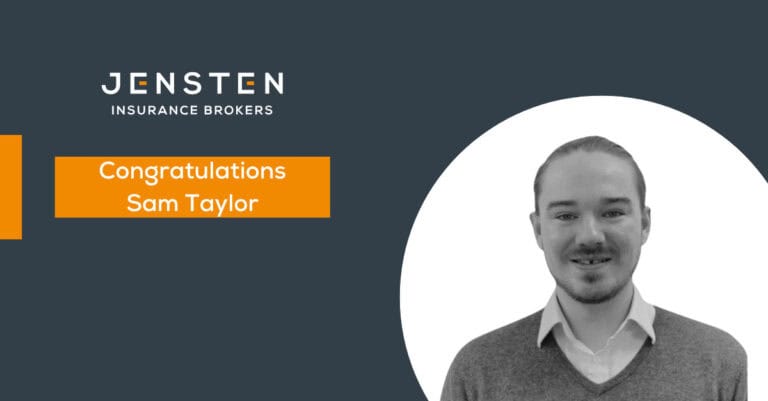 Professional insurance broker celebrating client success at Jensten Insurance Brokers.