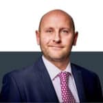 Professional insurance broker in formal suit, offering expert advice on insurance solutions.