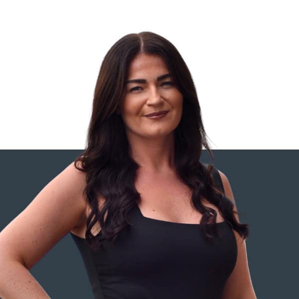 Jensten insurance broker woman smiling in professional attire, insurance solutions UK.