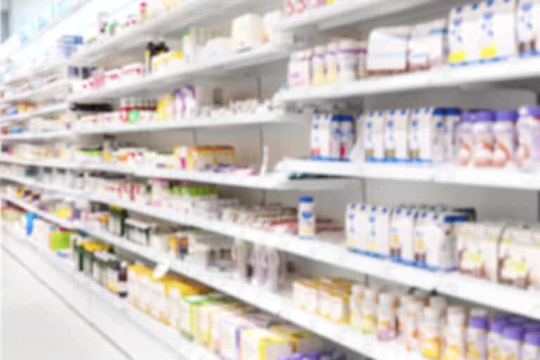 Vast assortment of pharmacy products on shelves at a retail store, showcasing health and wellness items.